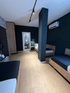 a bedroom with two beds and a blue wall at NOOR Boutique Hotel in Koplik