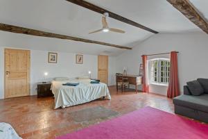 a bedroom with a bed and a couch in a room at Grand mas provencal in La Farlède +35 photos