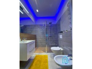 a bathroom with a shower and a sink and a toilet at NaWypasie Apartment with Sauna Beautiful Garden SUP Board and Just 30 Minutes from Gdańsk and Gdynia in Szemud +37 photos
