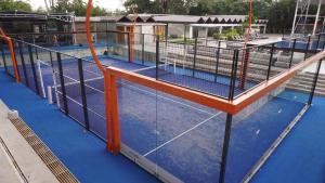a pool with a tennis court with a cage on it at Hotel & Casino Internacional Valencia in Valencia +22 photos