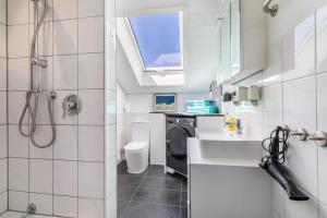a bathroom with a sink and a washing machine at Haus Fabio in Großengstingen +19 photos