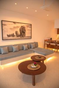 a living room with a couch and a table at One Ocean Hotel Apartments by Nest & Nomad in Msambweni