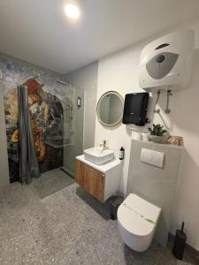 a bathroom with a toilet and a sink and a mirror at Motel Anić in Novi Travnik +51 photos