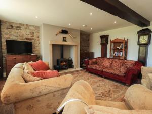 a living room with two couches and a fireplace at Ragged Hall Barn in Settle