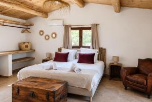 a bedroom with two beds and a chair at Ranch Campo Palombaggia in Porto-Vecchio +129 photos