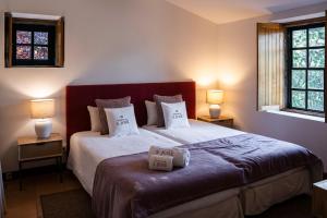 a bedroom with a bed with two pillows on it at Quinta De São José in Ervedosa do Douro
