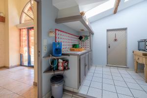 a kitchen with a counter and a door in a room at L'Etable de Sauvignac - Avec piscine privée in Sauvignac