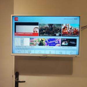 a flat screen tv hanging on a wall at Little studio in the old town in Vence