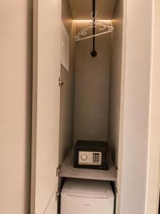 a small kitchen with a toaster on top of a refrigerator at Boutique Hotel Bora in Peje +15 photos