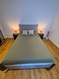 a bedroom with a large bed with two night stands at Gemütliche City Wohnung in Mönchengladbach