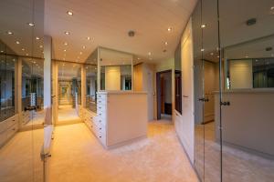 a large walk in closet with large mirrors at Jagdhaus Umlberg in Umlberg +60 photos