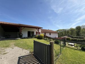 a house with a fence in front of a yard at Pegartea in Mendionde