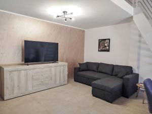 a living room with a couch and a flat screen tv at Apartment in Riga by Interhome in Cisano sul Neva