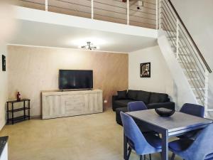 a living room with a couch and a tv at Apartment in Riga by Interhome in Cisano sul Neva +16 photos