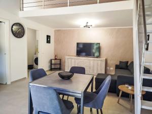 a living room with a table and chairs and a couch at Apartment in Riga by Interhome in Cisano sul Neva