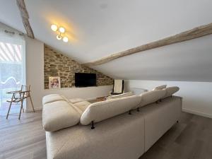 a living room with a couch and a tv at Etxean irria in Hasparren