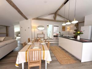 a kitchen and living room with a dining room and a table at Etxean irria in Hasparren