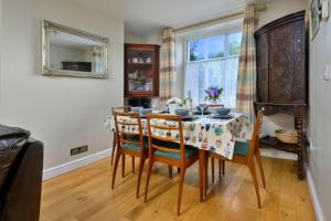 a dining room with a table and chairs and a window at Finest Retreats - Artro View in Llanbedr