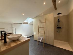 a bathroom with a sink on a counter and a ladder at Etxean irria in Hasparren +22 photos