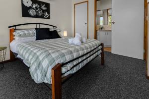a bedroom with a bed with two pillows on it at Paradise on Sheerwater in Paynesville
