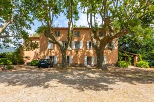 a house with trees in front of it at Grand mas provencal in La Farlède