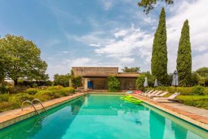a pool with chairs and a house with trees at Grand mas provencal in La Farlède