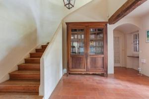 a staircase in a home with a wooden cabinet at Grand mas provencal in La Farlède