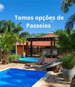 a swimming pool in a backyard with a gazebo at Pouso Canarinho in Carrancas