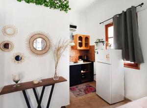 a kitchen with a white refrigerator and a table at Lerios in Vrachonisída Savoúra