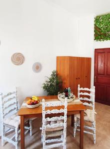 a dining room with a wooden table and chairs at Lerios in Vrachonisída Savoúra +9 photos
