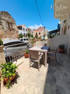 a patio with a table and chairs on a balcony at Lerios in Vrachonisída Savoúra