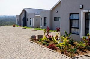 a house with a brick driveway in front of it at Ultimate Lotus in Manzini