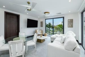 a living room with a white couch and a glass table at Pestica Villa Private Pool in Leeward