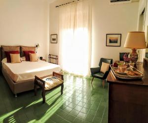 a bedroom with a bed and a table and chair at Il Mulino in Locri