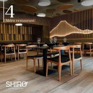 a dining room with a table and chairs with wine glasses at Hotel & Casino Internacional Valencia in Valencia