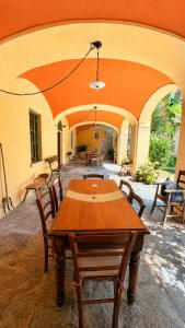 a patio with a wooden table and chairs at Apartment La Bigatera in Castelveccana