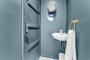 a blue bathroom with a sink and a mirror at Haregate House 3BR Leek Peak District Sleeps 5 in Leek +41 photos