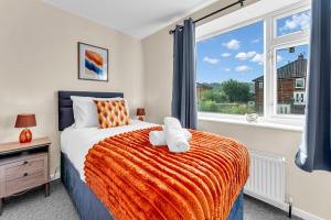 a bedroom with a bed and a window at Haregate House 3BR Leek Peak District Sleeps 5 in Leek