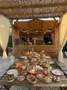 a table with plates of food on top of it at Il Melarancio in Pescia Romana