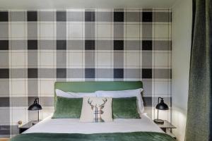 a bedroom with a bed with a green headboard at Betù Holiday Apartment in Castello di Fiemme +18 photos