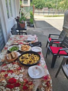 a table with food on it on a patio at Apartman Sadba 2 in Goražde +12 photos