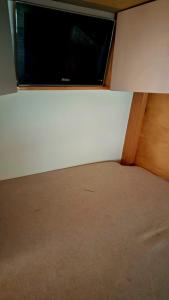 a bedroom with a flat screen tv on the wall at Van Home in Lavrinhas