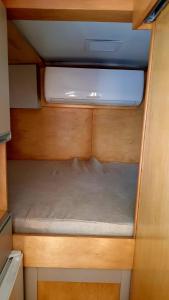 an inside view of a small bed in an rv at Van Home in Lavrinhas