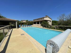 a swimming pool with a slide in a house at Villa Vallon Pont d'Arc in Vallon-Pont-dʼArc