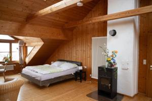 a bedroom with a bed in a room with wooden walls at Michlhof in Oberostendorf