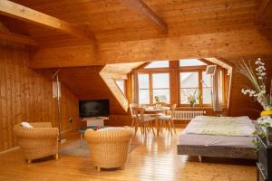 a room with a bed and a table and chairs at Michlhof in Oberostendorf