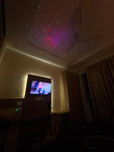 a room with a flat screen tv on a ceiling at Corestay in Greater Noida