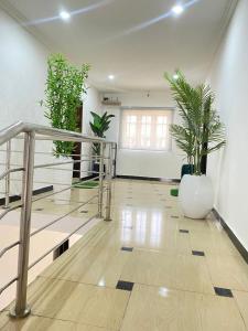 a hallway with potted plants in a room at Aprils homes & apartments in Ankuru