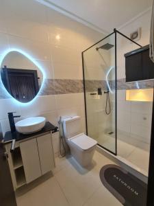 a bathroom with a toilet and a sink and a shower at Aprils homes & apartments in Ankuru