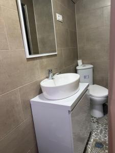 a bathroom with a sink and a toilet at Our village in Khoni +12 photos